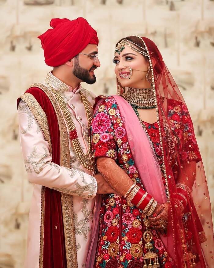 Candid Couple Shot - Bride in a Red Sequinned Lehenga and … | Indian wedding  photography poses, Indian wedding photography couples, Wedding couple poses  photography