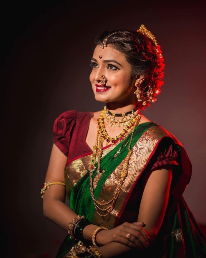 Photo of A happy Marathi bride in silk nauvari saree.